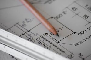 close up of architectural drawings and a pencil 