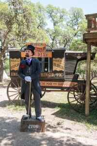 Snake oil salesman historical reactor standing on a soap box in front of a carriage