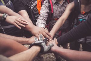 volunteers giving each other a group hand huddle
