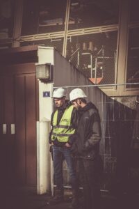 two construction workers on the job talking