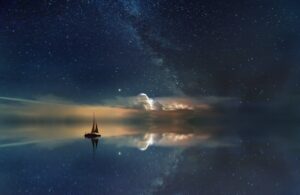 artistic photography of a sailboat and the night sky
