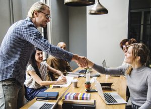 man shaking woman's hand