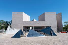 pyramids in front of a triangular building