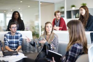 woman speaking to a diverse group of professionals
