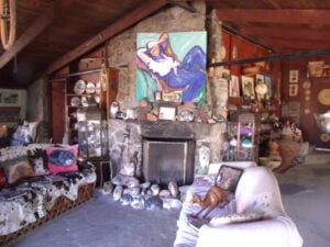 a room with two couches and various knickknacks
