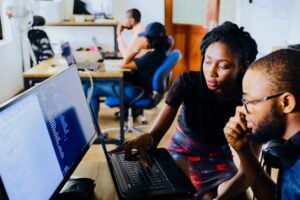 two employees looking at a computer screen