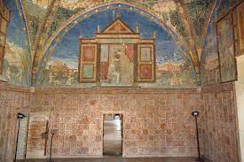 a ceiling painted with a mythological figure from the inside of the Torrechiara Castle