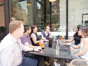 employees collaborating at an outside cafe