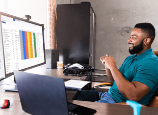 Preconstruction professional looking at DESTINI Bid Day bid leveling software on his computer. 