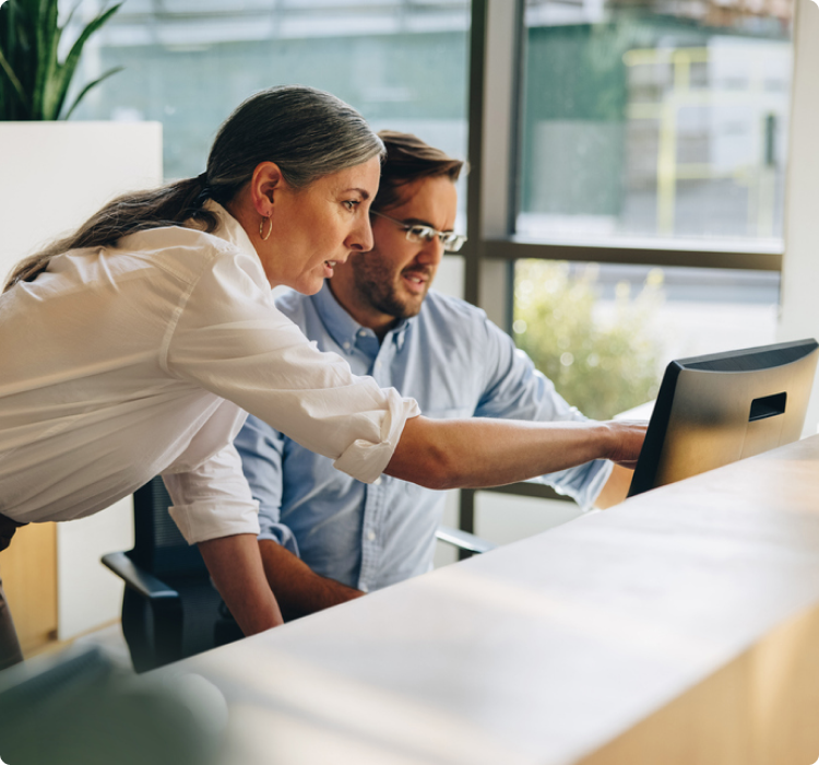 Man and woman looking at computer screen.