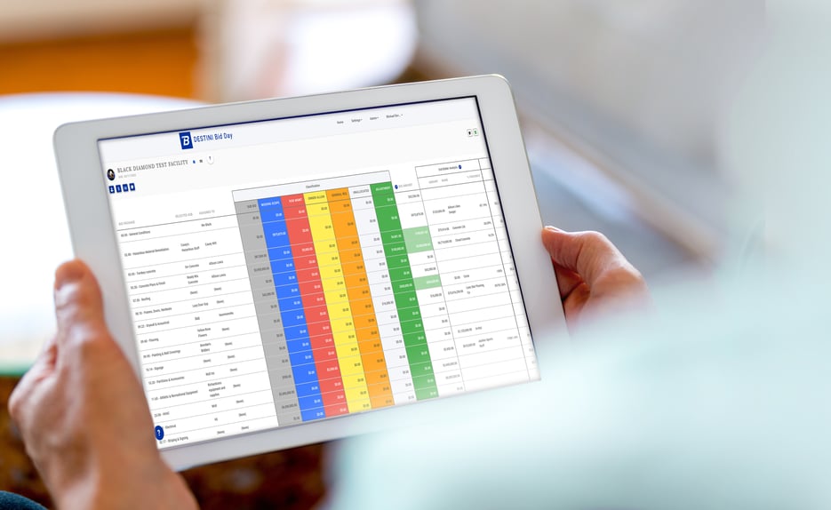 Preconstruction estimator comparing multiple subcontractor bids side by side using construction bid leveling software.