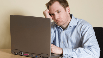 confused man at laptop