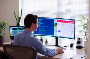 man sitting at a desk working on construction estimating software